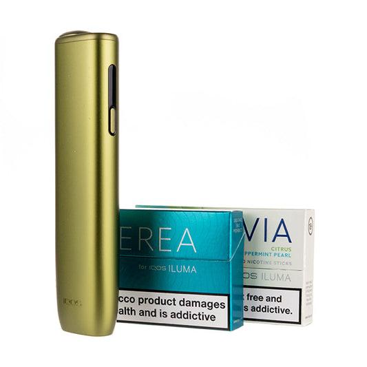 Gold vape device with a box of Via Nicotine Pouches on a white background