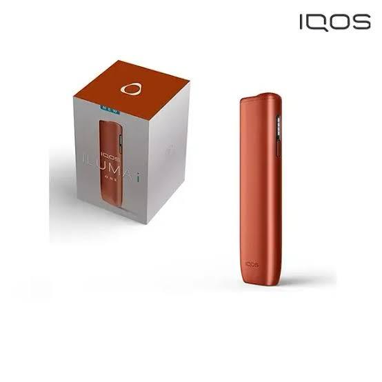 Red IQOS device with packaging on a white background